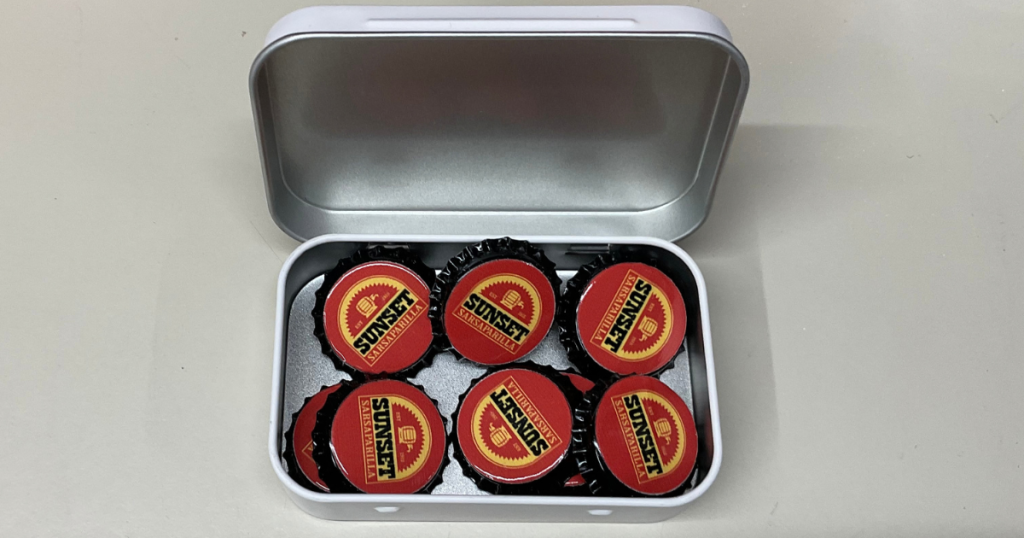 Sunset Sarsaparilla Lucy Tin Box with 8 Bottle Caps